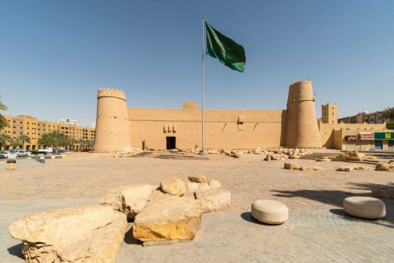 National Saudi flag flying in front of the Masmak fortress in Riyadh old town in Saudi Arabia